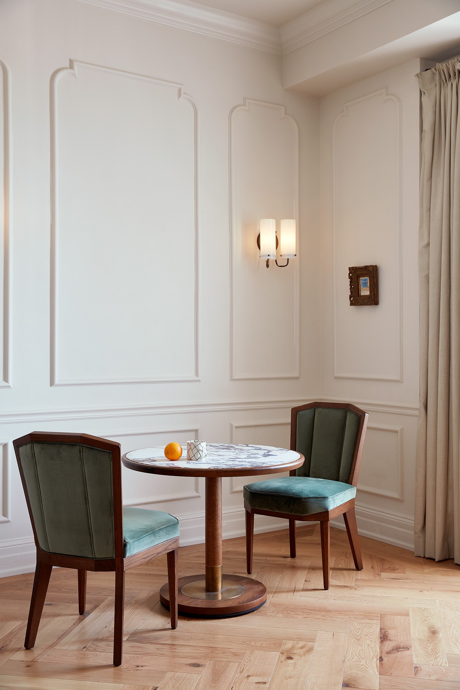 A round dining table with two chairs