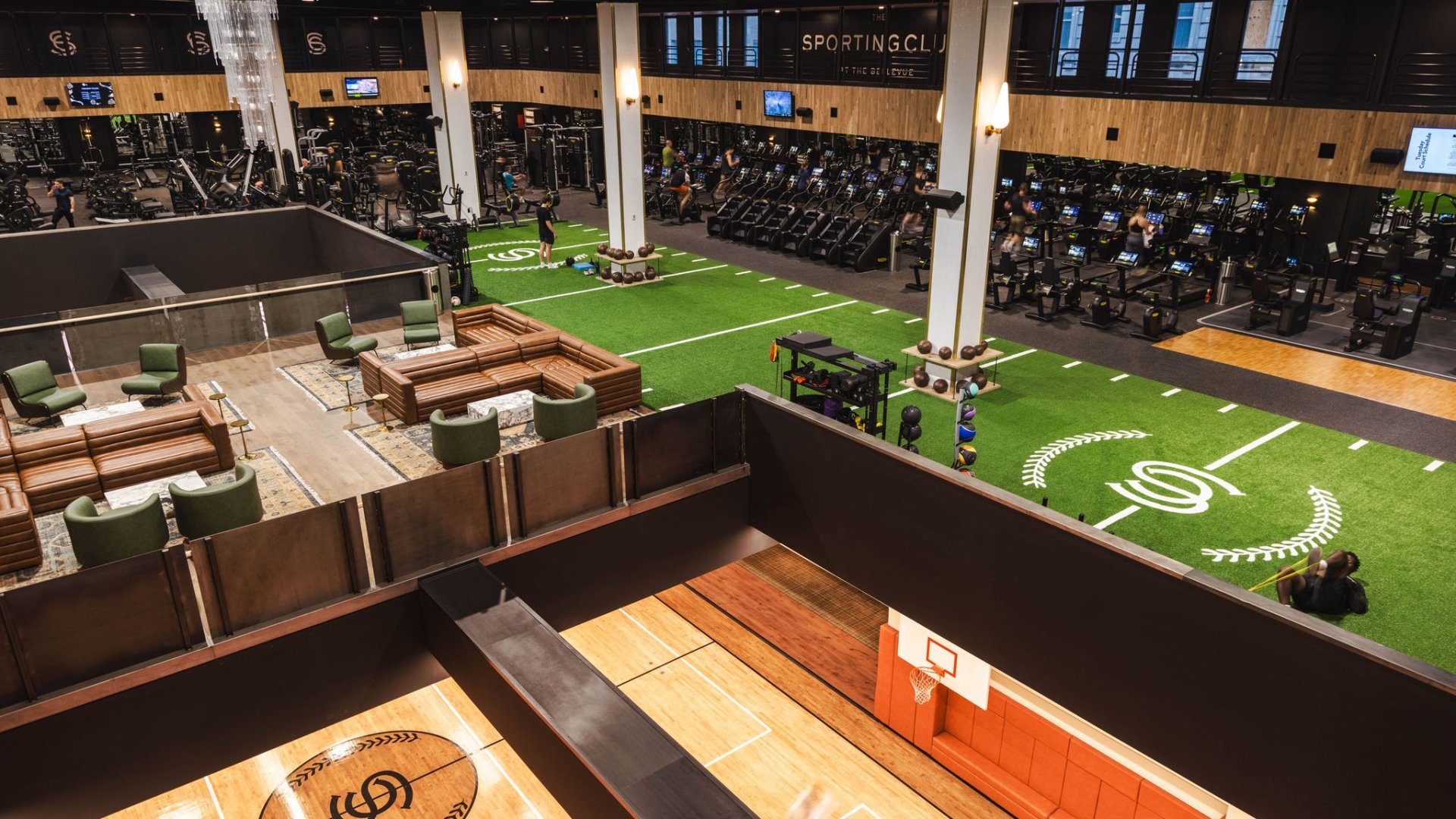 An overview shot of The Sporting Club‘s fitness floor, with view to its basketball courts and social suites.