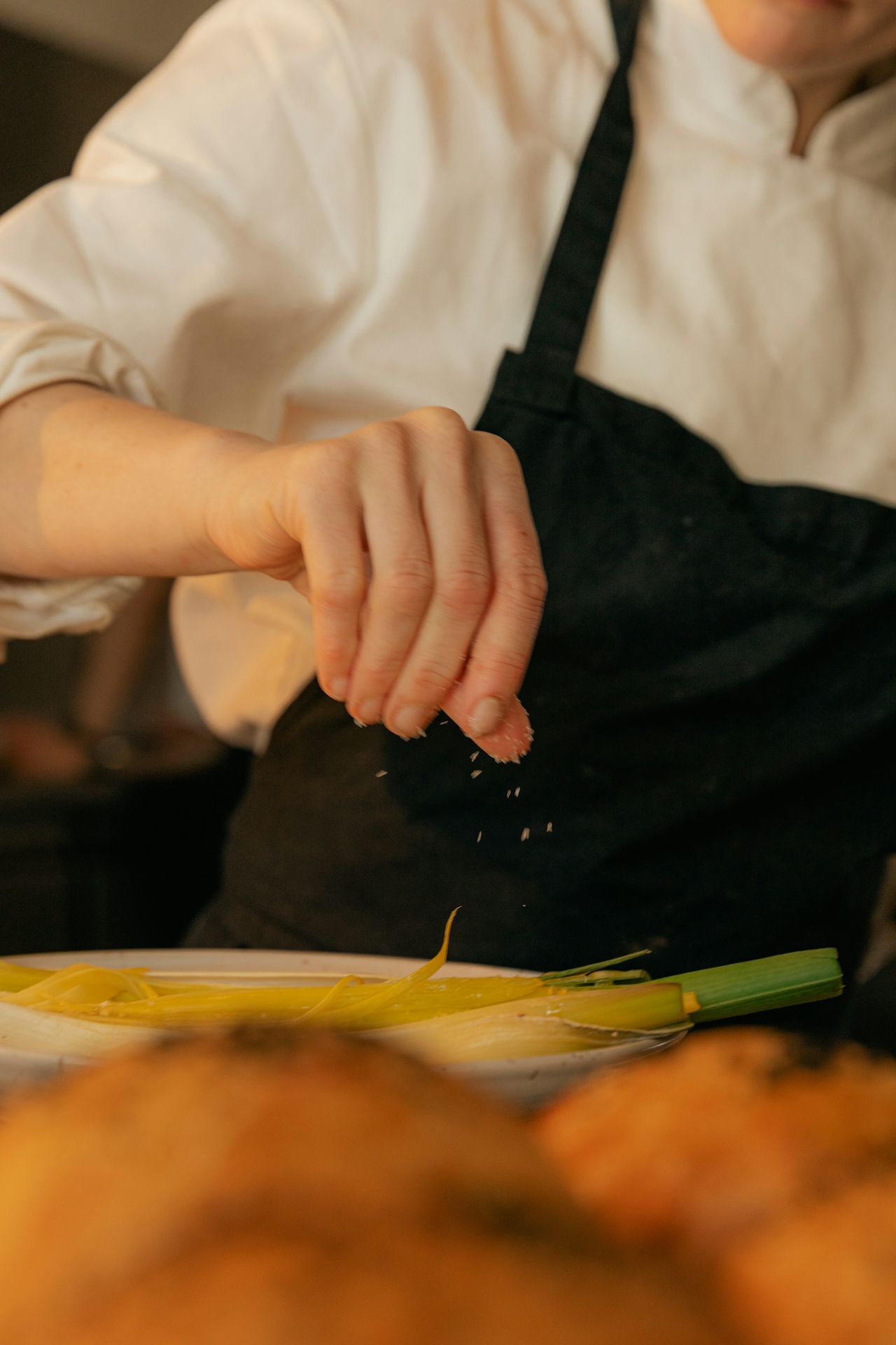 chef salting a dish