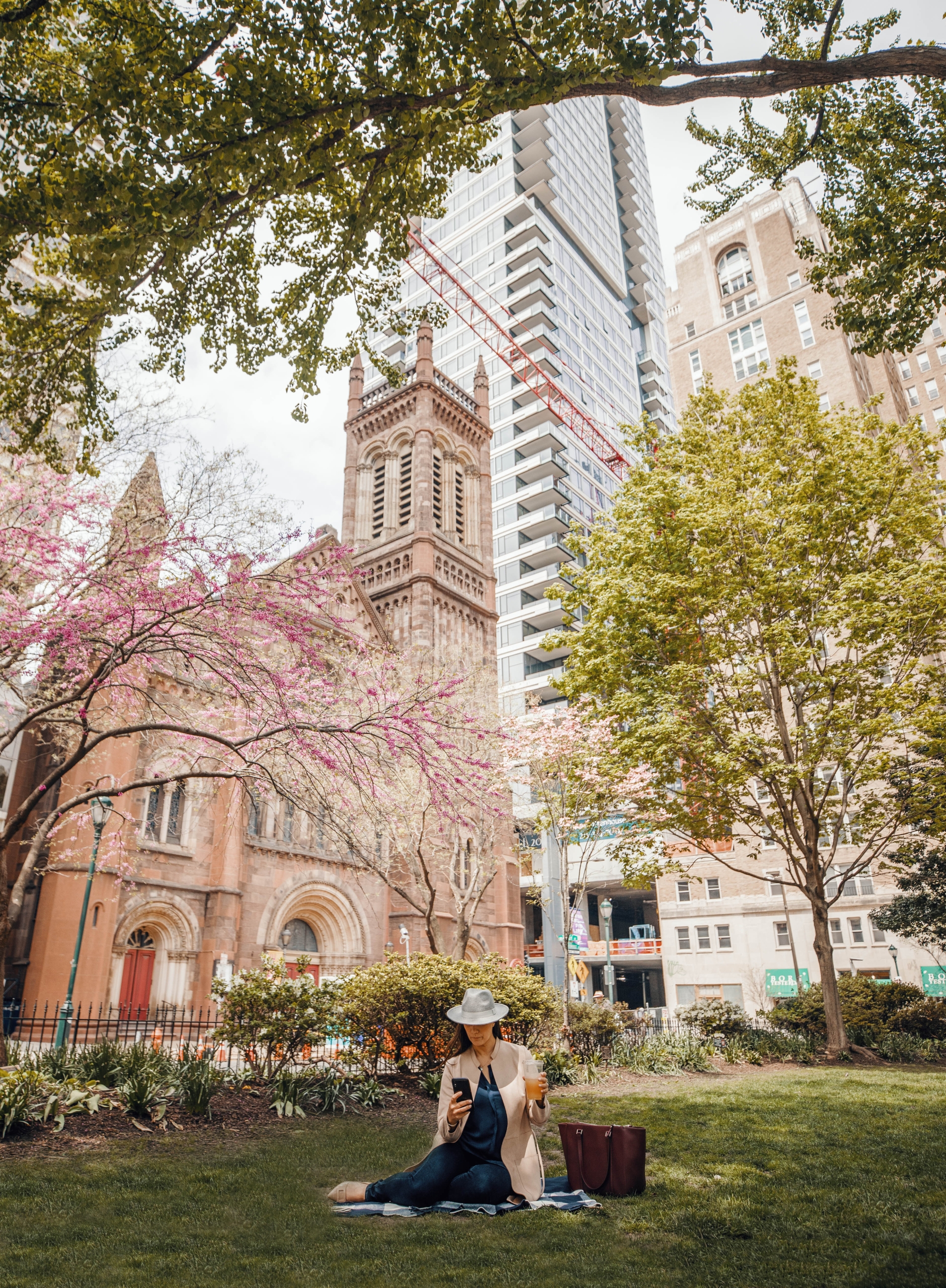 A woman sitting in the park in Spring in Rittenhouse Square