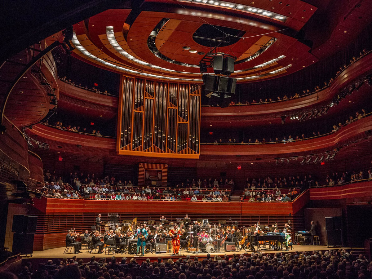 A shot of the stage and surrounding balconies at the Kimmel Center. The full orchestra is on stage during a performance